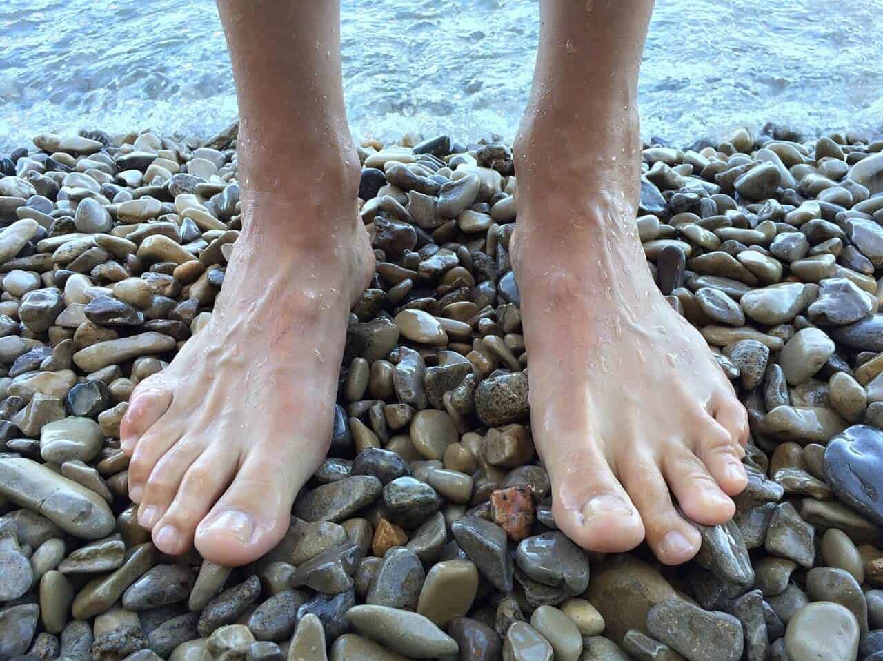 two feet on rocky beach