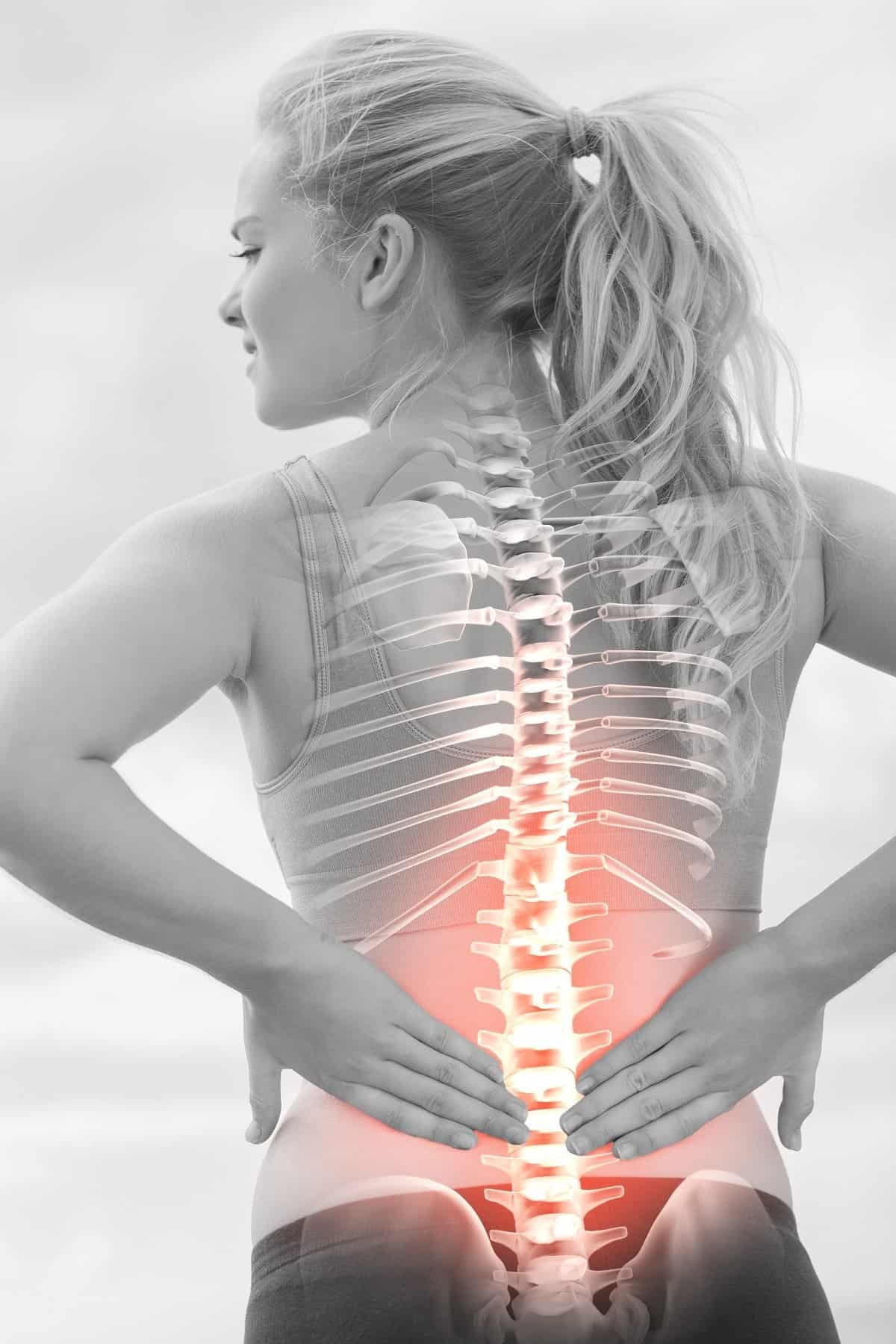 woman holding her back in pain, you can see her spine like you would on an xray