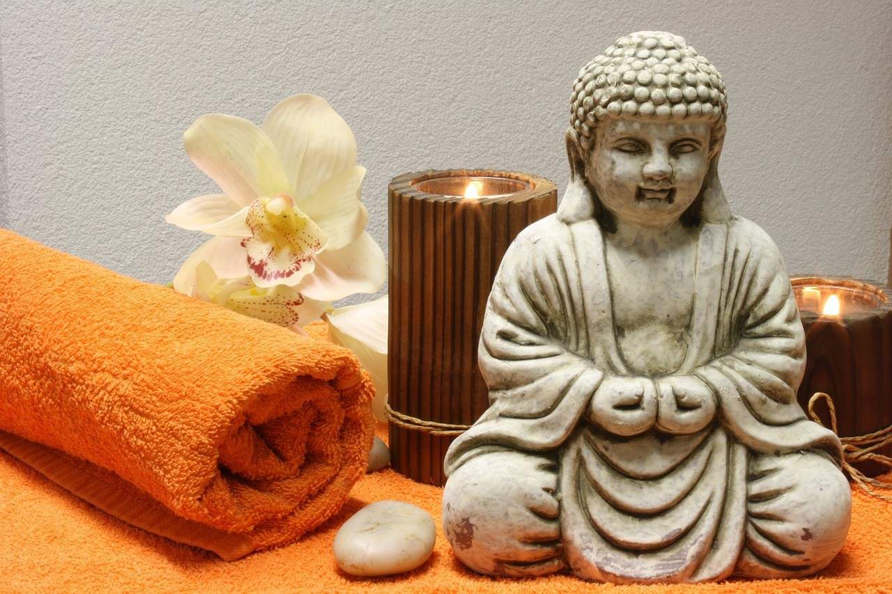 buddha, towels, candles, and flowers